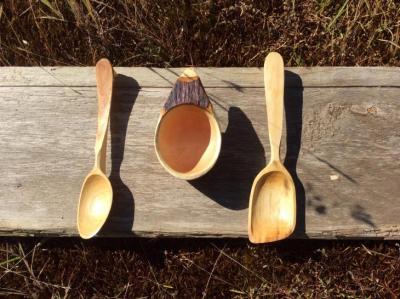 A hand carved arbutus coffee cup and acouple of spoons
