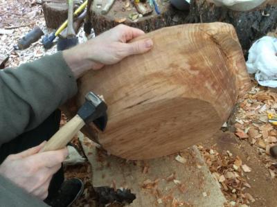 Carving the outside of an alder bowl with an adze.